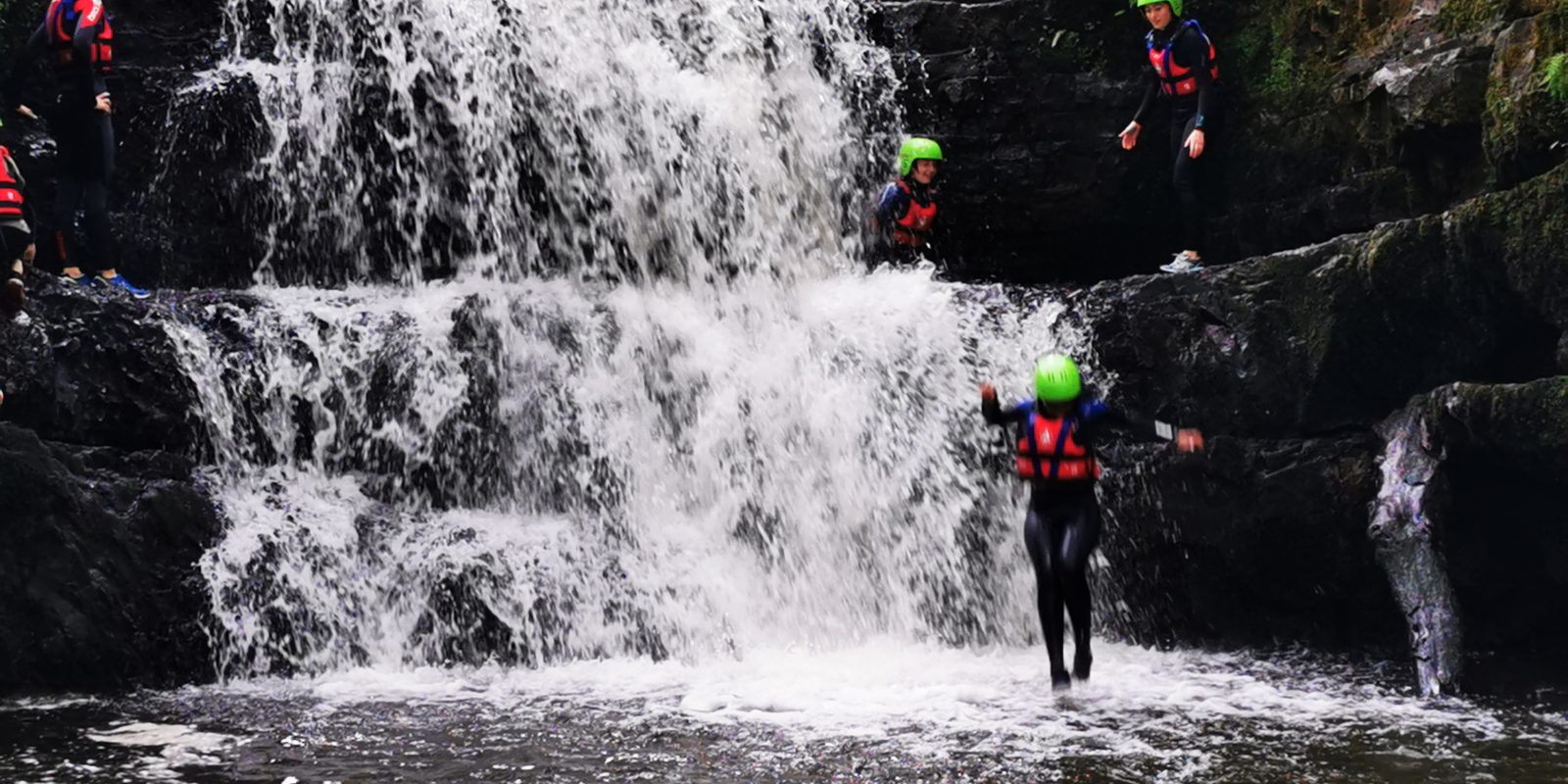 Young people jumping into a river and the bottom of a waterfall on the Atlantic Adventure Experience programme