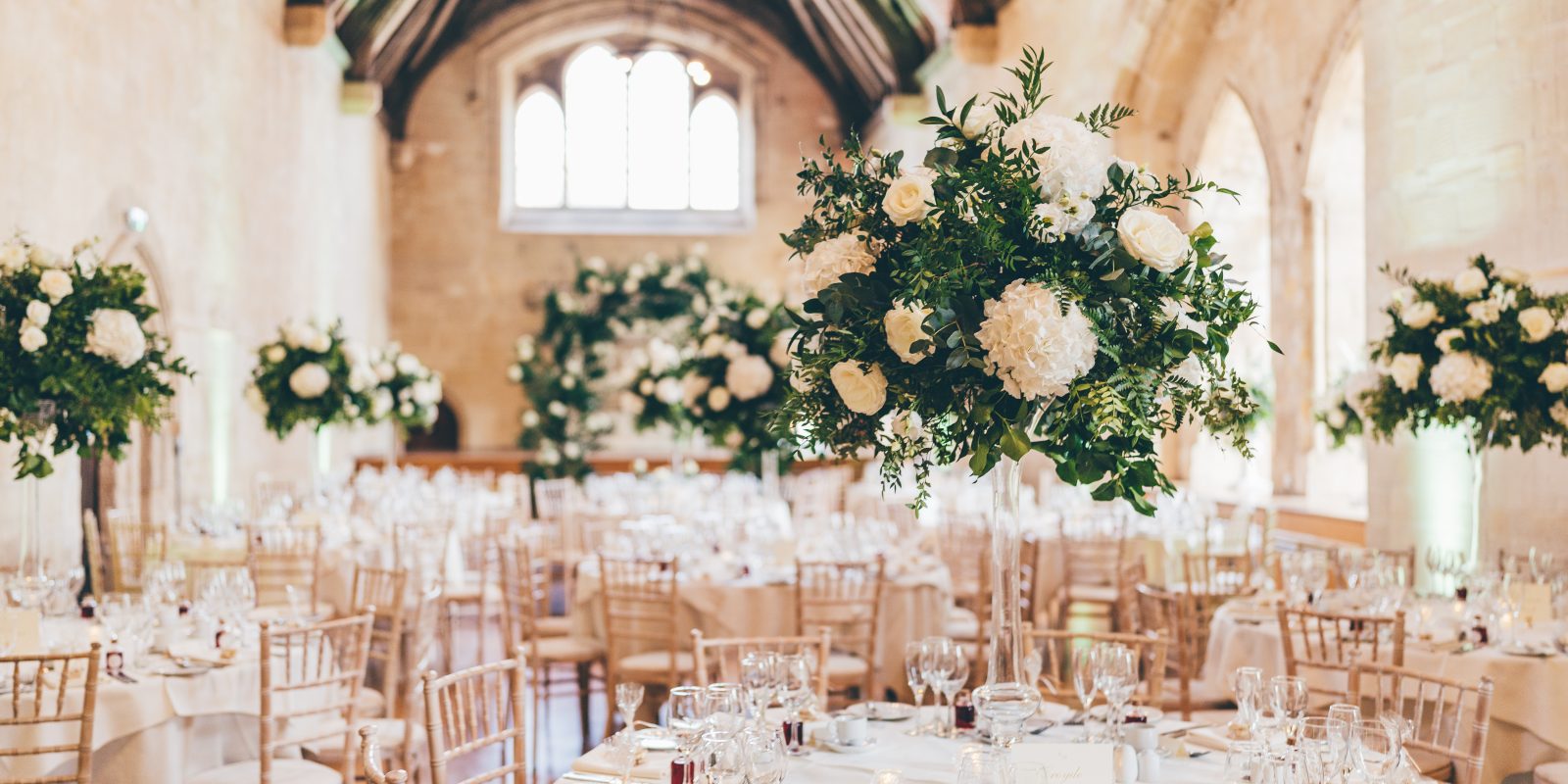 Bradenstoke Hall setup for a wedding breakfast with floral centre pieces