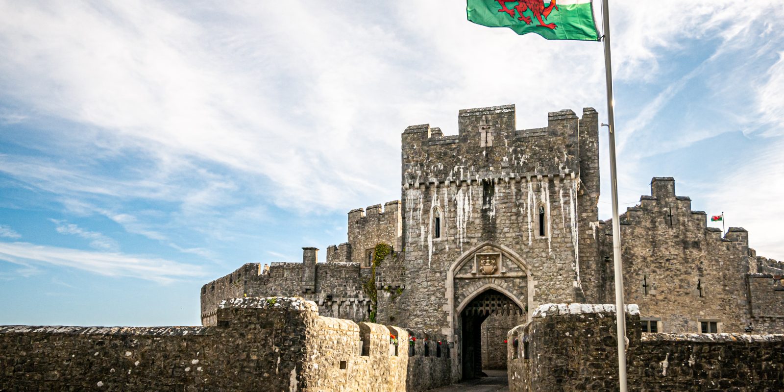 Portcullis entrance to St Donat's Castle with welsh flag flying