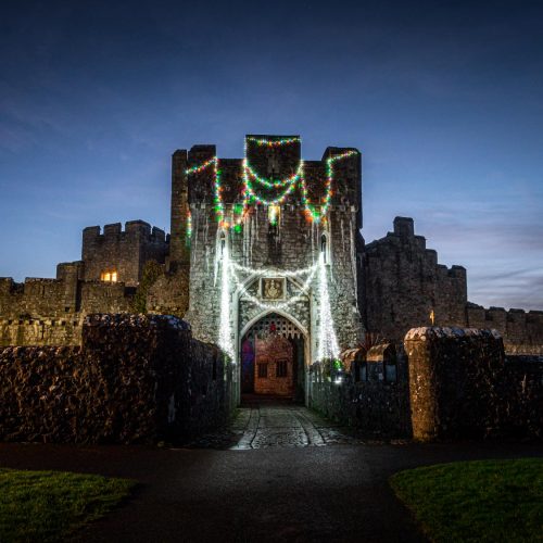 St Donat's Castle with Christmas lights draped at nighttime