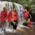 AAE students standing under waterfall