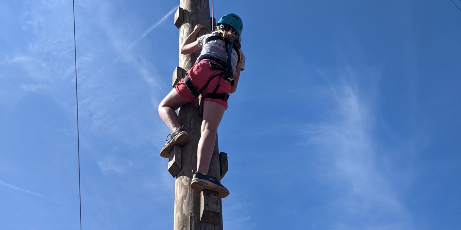 children climbing wobbly pole activity