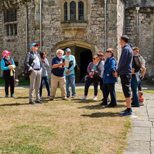 group of people having a tour of St Donat's Castle