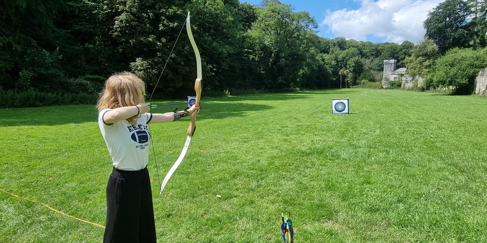 girl doing archery at St Donat's Castle