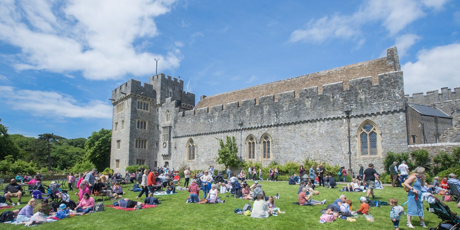 Crowds of people sat in front of St Donat's Castle