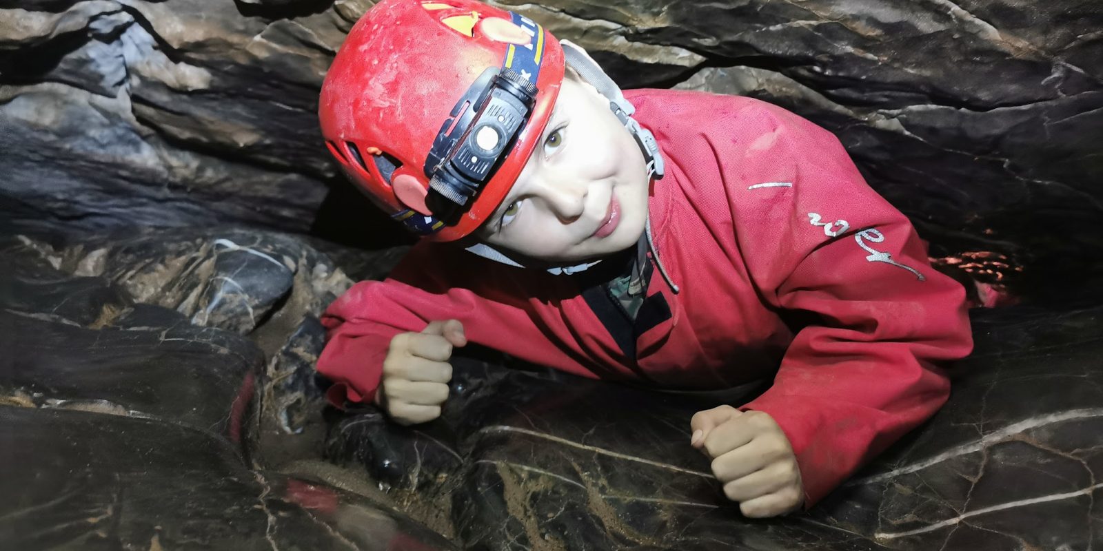 Young child in red caving