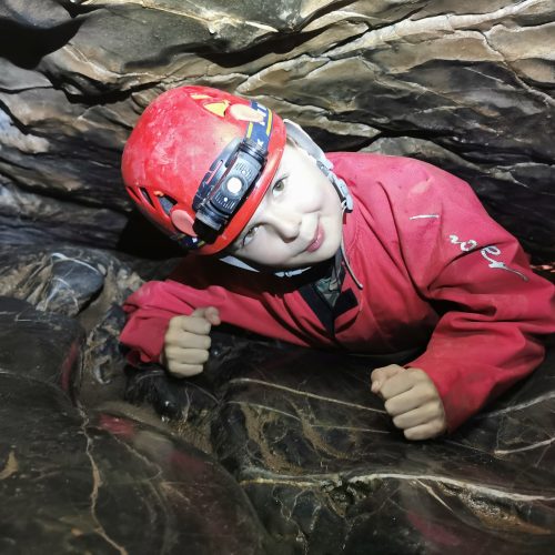 Young child in red caving