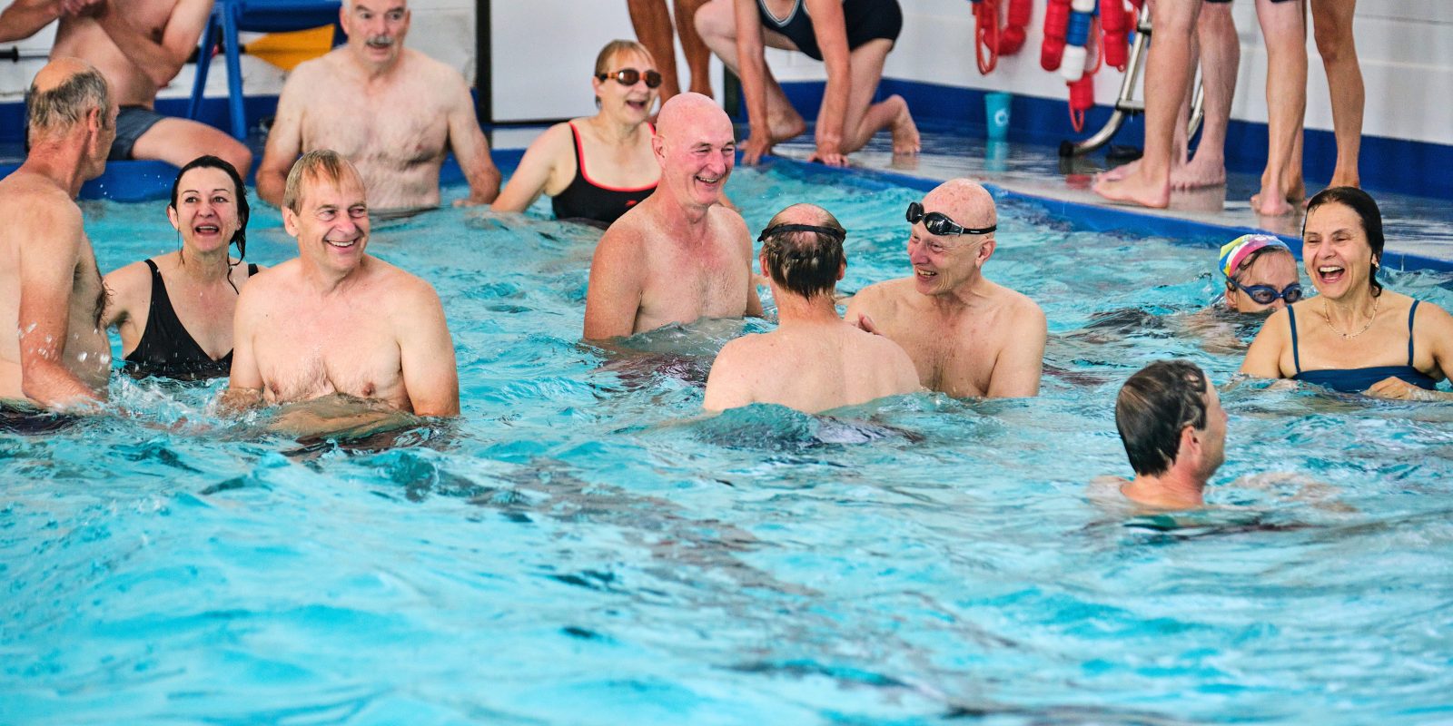 Adults swimming in pool