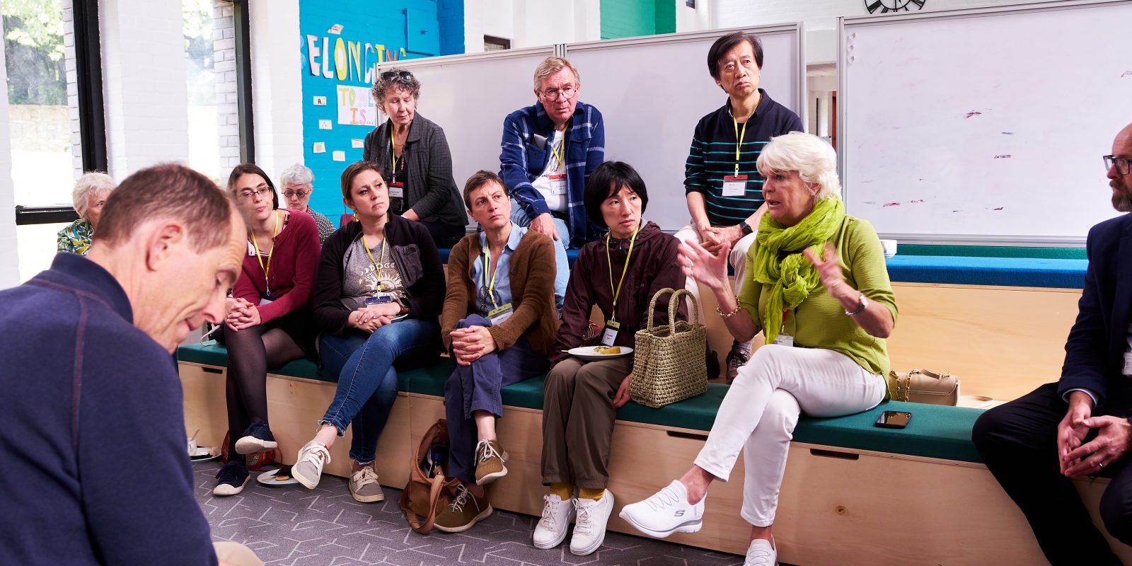 Group of adults on a UWC education course talking and discussing in a classroom environment