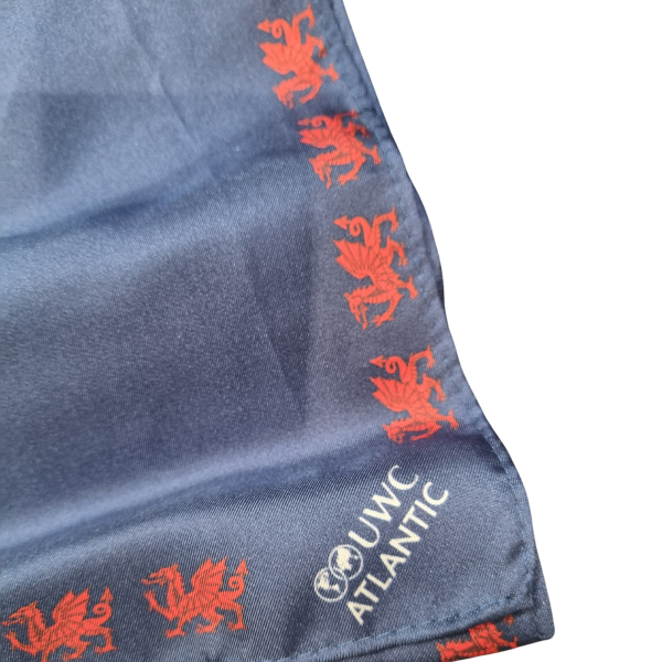 blue silk dinner scarf with red Welsh dragon border and white UWC Atlantic logo