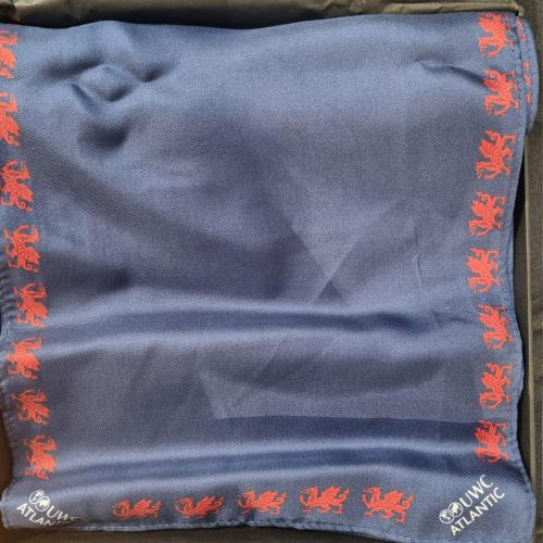 Blue ladies dinner scarf with red dragon design and white UWC Atlantic logo