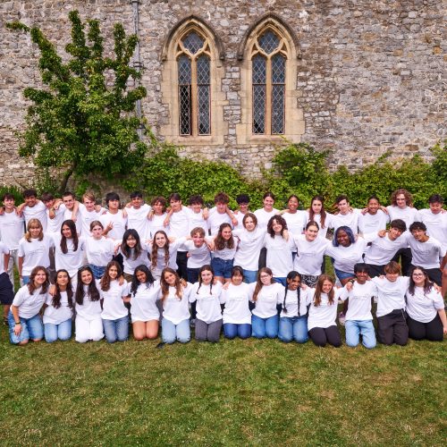 Group of GLE participants in white GLE tshirts in front of St Donat's Castle