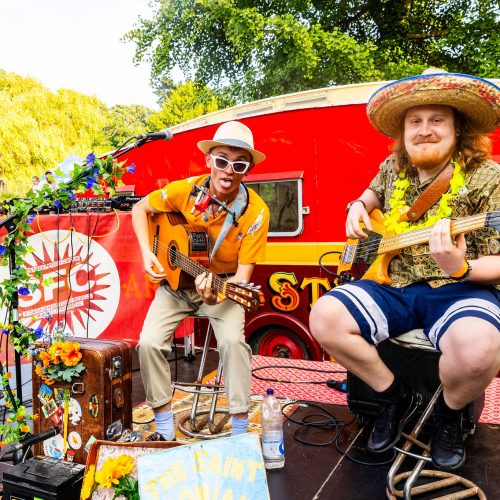 Performers playing guitars at the street food circus event