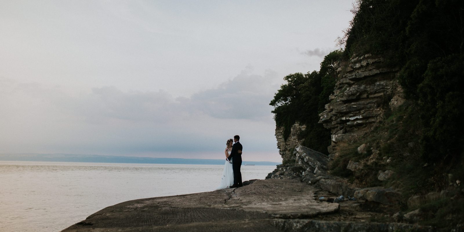Wedding couple on the coast of St Donat's Bay